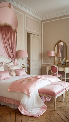 a bed with pink sheets and pillows in a bedroom