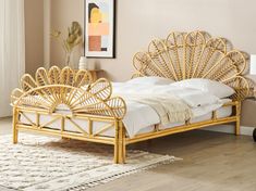 a bed that is made up with wicker and white linens on the floor