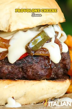 a close up of a hamburger with cheese and peppers