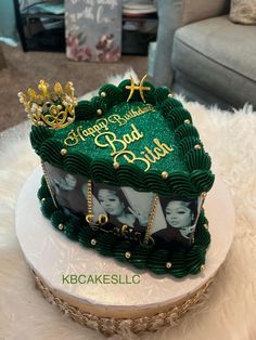 a green cake with photos on it sitting on top of a table