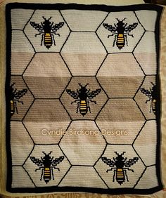 a crocheted blanket with bees on it