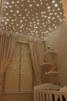 a baby's room is decorated with white lights