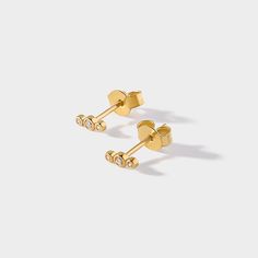 When it comes to diamonds decorating our ears - its three times the charm, three times the beauty. Dainty stud earrings, for all your ear stacking needs. Details: Earring overall size: 5.2mm x 2.1mm 100% recycled 14K Yellow Gold VVS2, G colour lab grown diamonds, total 0.06 carats Ear Stacking, Trillion Diamonds, Diamond Solitaire Earrings, Necklace Length Guide, Diamond Huggies, Color Lab, Dainty Studs, Diamond Stud Earrings, Affordable Jewelry