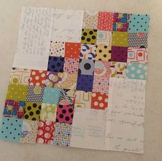 a piece of paper that has been made into a patchwork quilt with polka dots on it