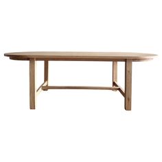 a wooden table with two legs and a long oval shaped top, against a white background