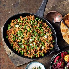 the meal is prepared and ready to be eaten on the wooden platter, along with other dishes