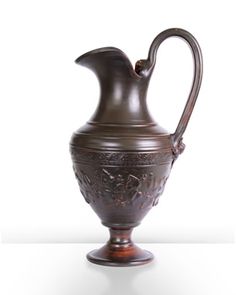 an ornate bronze vase is shown against a white background