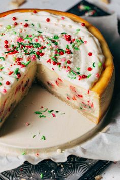 a cake with white frosting and sprinkles on it