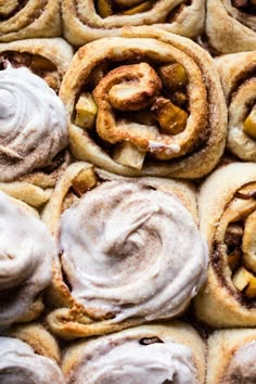 cinnamon rolls with icing and apples on top