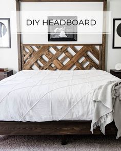 a bed with white sheets and wooden headboard