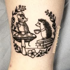 a tattoo on the leg of a person with a hedge and mushroom in front of them