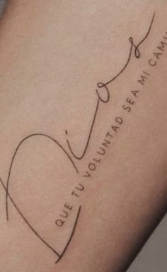 a woman's thigh with the word love written in cursive writing