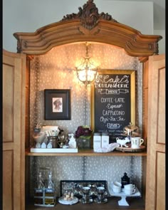 an old fashioned china cabinet is filled with teas and coffee cups, along with a chalkboard sign on the wall