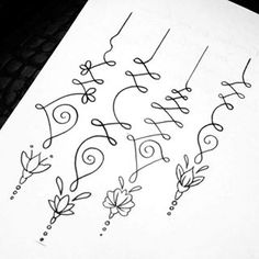 a sheet of paper that has some writing on it with flowers and vines drawn on it