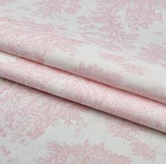 pink and white fabric with floral designs