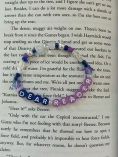 an open book with a bracelet that says dear peace on it and the words dear peace written