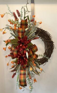 a wreath hanging on the wall with flowers