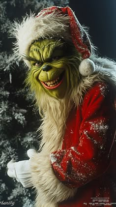 a man dressed as the grinch in front of a christmas tree with snow on it