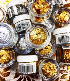 several jars filled with gold and silver glitter