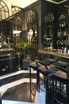 a bar with black leather chairs and gold trimmings