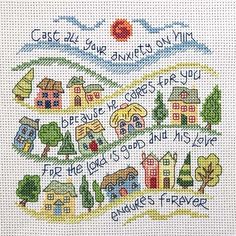 a cross stitch pattern with houses and trees on the bottom, and words written in different languages