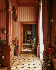 an ornate hallway with striped walls and flooring