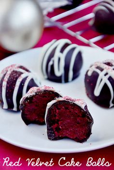 red velvet cake balls on a plate with white icing and chocolate drizzles