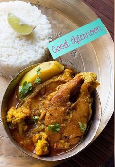 a silver plate topped with rice and curry