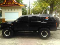 a black suv parked in front of a house