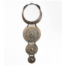 This is a mid-20th century Hmong neck ring or necklace that was crafted of low grade silver in the traditional Hmong manner. The Hmong are renown for their silver making skills. Women wear the traditional silver neck rings as amulets which protect the wearer's spirit from leaving the body. This particular neck ring is in very good condition with normal signs of wear. The custom iron stand allows the neck ring to be a unique decorative element suitable for integration into a mid-century minimal design or into a traditional scheme. Neck Rings, Neck Ring, Iron Stand, Amulets, Minimal Design, Manners, 20th Century, Rust, Mid Century