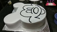 a white cake with black writing on it