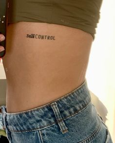 a woman's stomach with the word self control tattooed on her left side ribcage