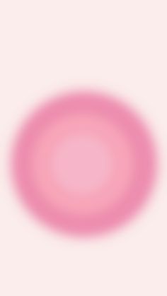 a blurry image of a pink circle in the middle of a light pink background