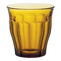 a yellow glass vase sitting on top of a table