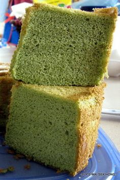 three pieces of green cake sitting on top of a blue plate next to each other