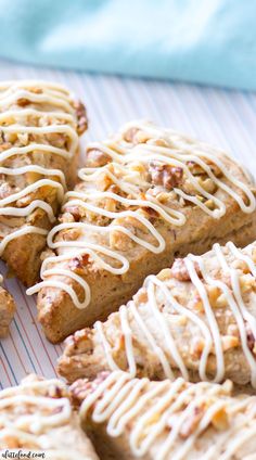 several pieces of bread with icing sitting on a table