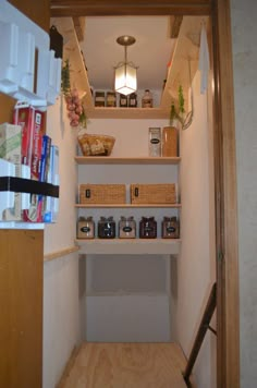 an empty pantry with shelves and baskets