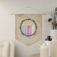 a wall hanging with candles on it