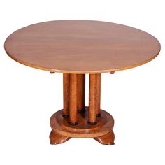 a round wooden table with two pedestals on each side