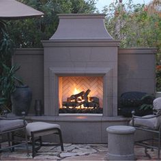 an outdoor fireplace surrounded by chairs and tables