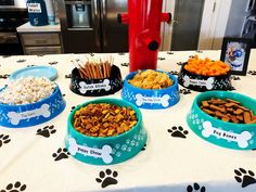 several bowls of dog food on a table