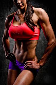 a woman in a red sports bra top with her hands on her hips