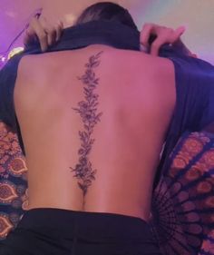 a woman with a tattoo on her back