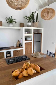 some bananas are sitting on a counter in a room with white walls and wood floors