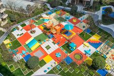 an aerial view of a colorful playground with lots of play equipment