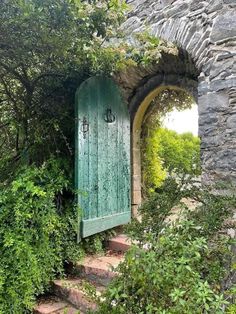 an open door in the side of a stone building with stairs leading up to it