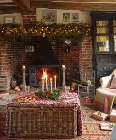 a living room filled with furniture and a fire place covered in christmas garlands next to a fireplace