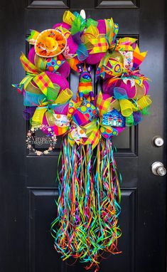 a colorful wreath is hanging on the front door