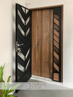 an open wooden door with black and white designs on the front, inside and outside