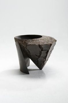 a black vase sitting on top of a white table